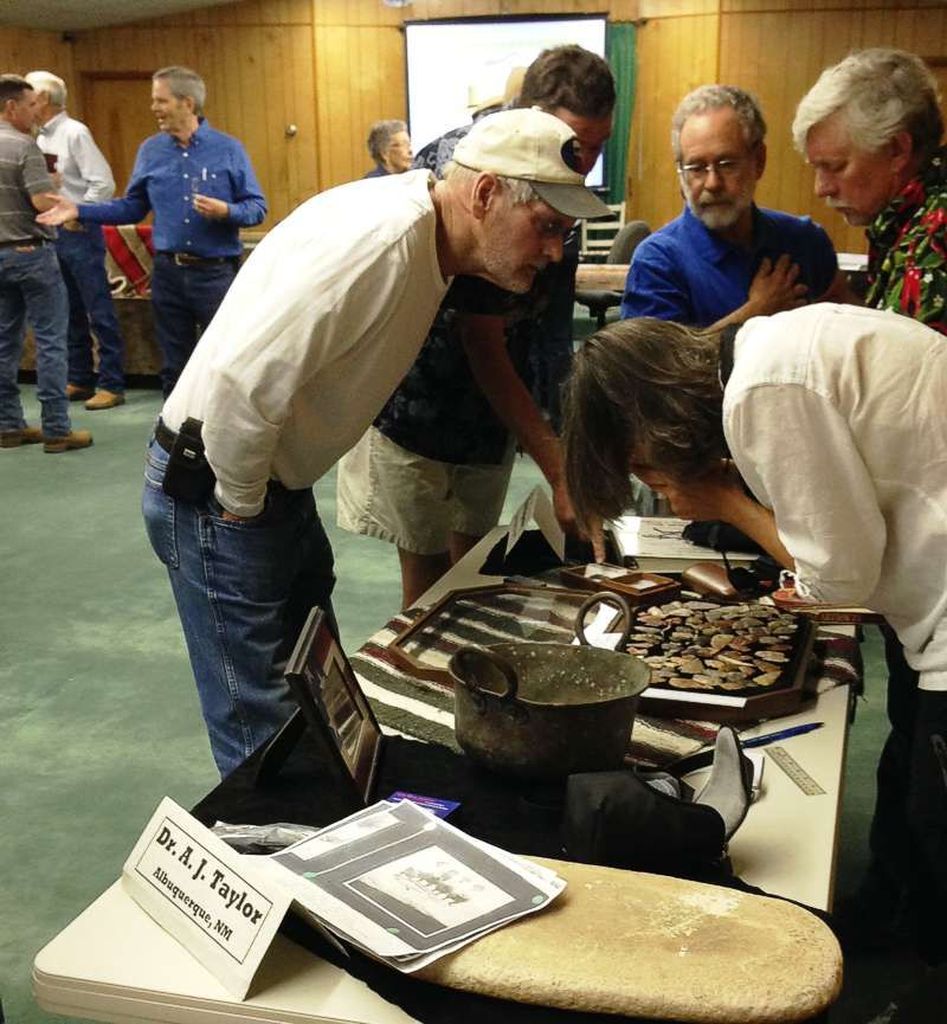 Dr. A.J. Taylor examines stone age artifacts donated to the museum.