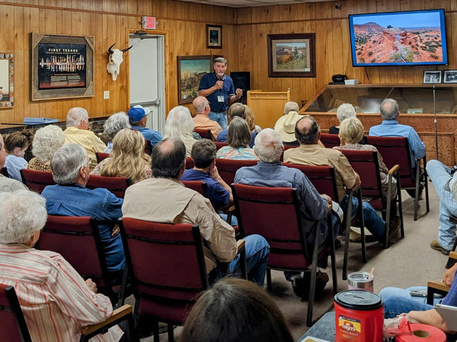 Rick Day speaking to a full audience.